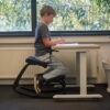 Child writing at modern desk chair, knee chair